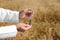 Agronomist holding test tube with soil sample in field. Cereal farming