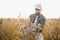 Agronomist inspects soybean crop in agricultural field - Agro concept - farmer in soybean plantation on farm.