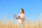 Agronomist with laptop in field. Cereal grain crop