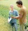 Agronomist looking at wheat quality with farmer at field with cr