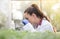 Agronomist with microscope in greenhouse