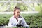 Agronomist with microscope in greenhouse