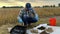 Agronomist preparing soil analysis, pouring soil sample flask outdoors