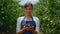 Agronomist present harvested cherry in orchard. Woman farmer hands holding berry