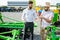 Agronomist with salesman at the shop with agricultural machinery