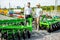 Agronomist with salesman at the shop with agricultural machinery