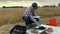 Agronomist tuning digital device for soil measurements at field dawn