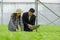 Agronomist and young woman asian farmer discussion and checking fresh green oak lettuce salad, organic hydroponic vegetable