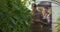 Agronomists woman and man with tablet working in greenhouse with cucumbers.