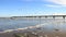 Aground. Baltic Seashore With Sea Wave And Long Bridge With Foam