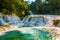 Agua Azul, Chiapas, Palenque, Mexico. Landscape on a magnificent waterfall with a turquoise pool surrounded by green trees.