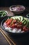 Ahi poke made of raw tuna chunks tossed over rice & topped with vegetables AI generated