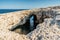 Ahrax fallen cave,Malta.Hole in the middle of rocks with crystal clear water inside.Rocky Maltese coast.Perfect spot for diving.