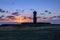 Ahu Tahai Moai Statue wearing topknot with eyes painted at sunset near Hanga Roa - Easter Island, Chile