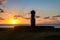 Ahu Tahai Moai Statue wearing topknot with eyes painted at sunset near Hanga Roa - Easter Island, Chile