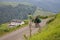 Ahusquy, Irati, France - July, 31, 2013 - basque man walking beside working donkey carrying load to the village in green valley