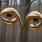 AI generated artwork consisting of a pair of eyes perched in golden brackets
