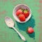 AI generated bowl of freshly picked strawberries with a spoon