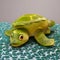 AI generated green colour smiling turtle on a green surface