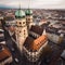 AI generated illustration of an aerial view of cityscape with tall clock towers