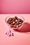 AI generated illustration of A bowl of assorted  chocolates with a pink background
