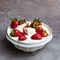 AI-generated illustration of a bowl full of strawberries in whipped cream