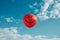 AI generated illustration of a cheerful smiley face balloon drifting in sunny skies