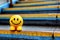 AI-generated illustration of a cheerful yellow smiley face on the stairs