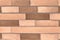 AI generated illustration of a close-up of a brick wall, composed of a variety of colored bricks