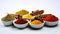 AI generated illustration of a collection of spices in white bowls, presenting a spectrum of flavors