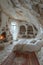 AI generated illustration of a cozy bed nestled in a cave style room