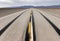 AI generated illustration of a desolate road stretches across a desert landscape