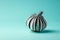 AI generated illustration of a garlic bulb with a unique black and white zebra-striped pattern