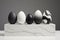 AI-generated illustration of a minimalist display of five decorative egg sculptures