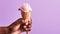 AI generated illustration of a person holding a cone full of ice cream on a purple  background