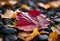 AI generated illustration of a red leaf atop black stones, surrounded by yellow leaves