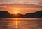 AI generated illustration of a stunning, glowing sunset illuminating the tranquil lake