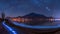 AI generated illustration of a stunning lakeside scene at night, adorned with twinkling lights