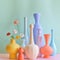 AI-generated illustration of A symphony of pastel vases creates a serene vignette