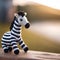 AI generated illustration of a tiny knitted zebra sitting and looking