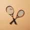 AI generated illustration of two tennis rackets on an orange background