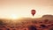 AI generated illustration of A vibrant red hot air balloon soars over the desert landscape at sunset