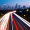 AI generated illustration of a wide L.A. road with bright long exposure lights at dusk