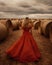 AI-generated illustration of a woman wearing a red dress looking at the hay bales