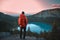 Ai generated image of a hiker on top of a mountain looking at an alpine lake