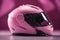 An ai generated image of pink motorbike helmet for women
