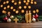 ai generated image presents a table adorned with golden candles and Christmas decorations.