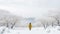 AI-Generated Minimalist Photo: Yellow-Dressed Man\\\'s Silhouette in Snowy Landscape with Trees