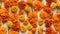 AI generated Orange marigold flowers on orange background. Top view. Flat lay