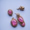 Ai generated a pair of pink stone earrings and a pair of regular earrings on a white background